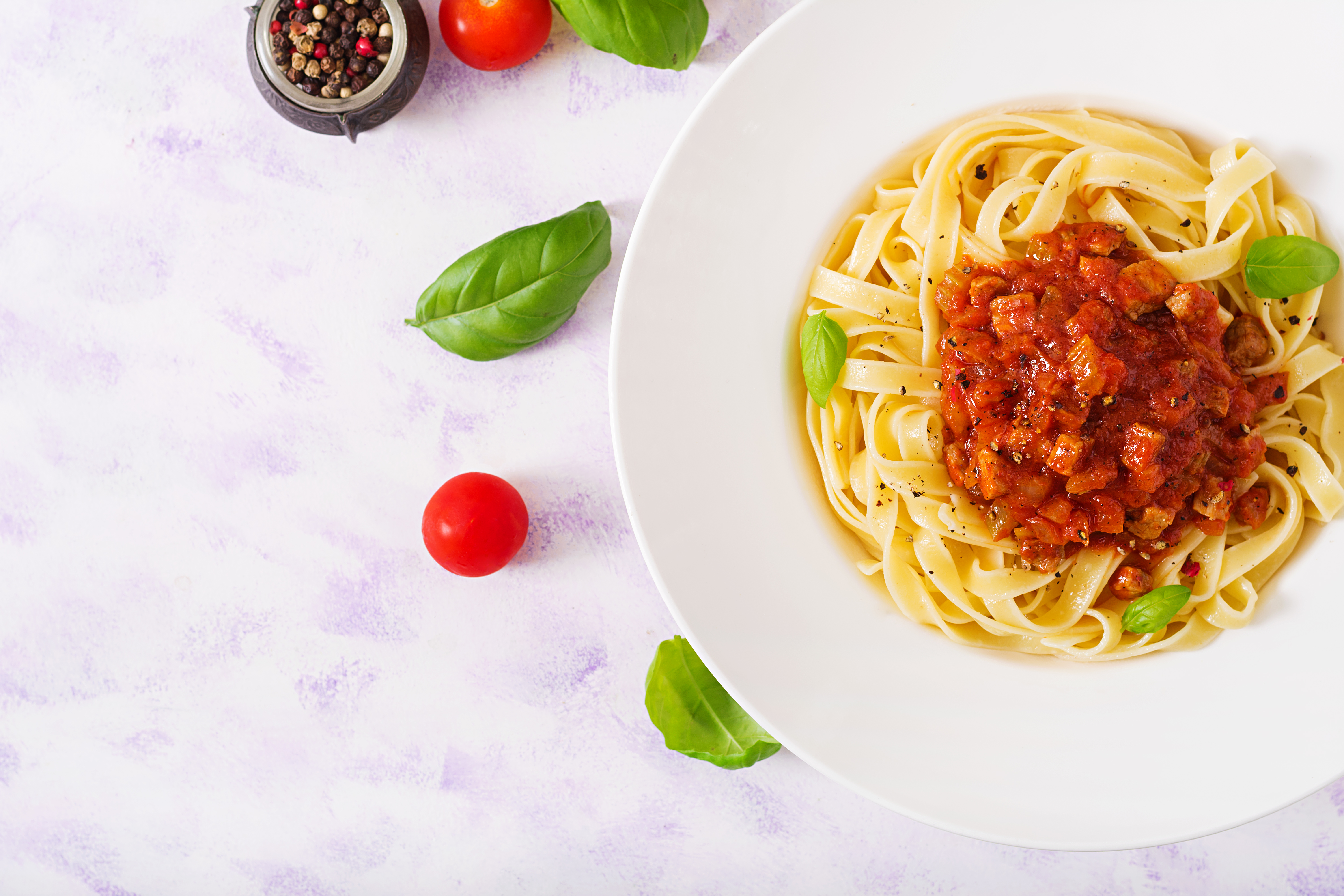 pasta fettuccine bolognese with tomato sauce white bowl flat lay top view